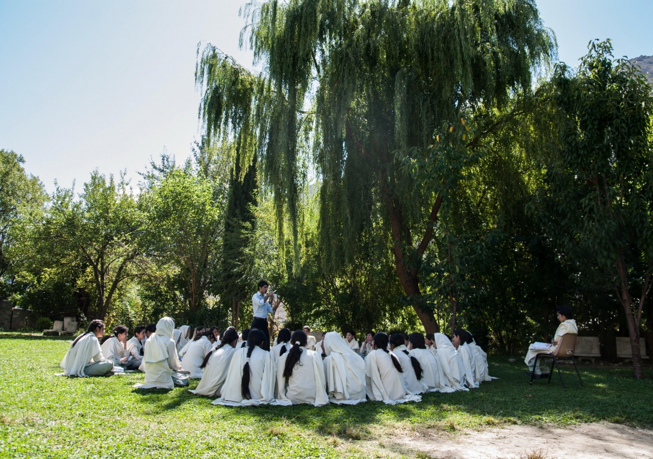 A teacher conducts a practical lesson outdoors