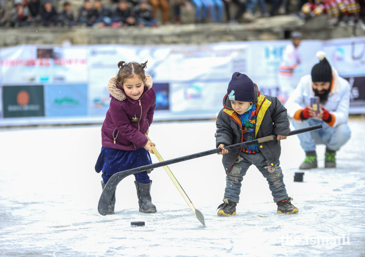 Young children practice their ice hockey skills.