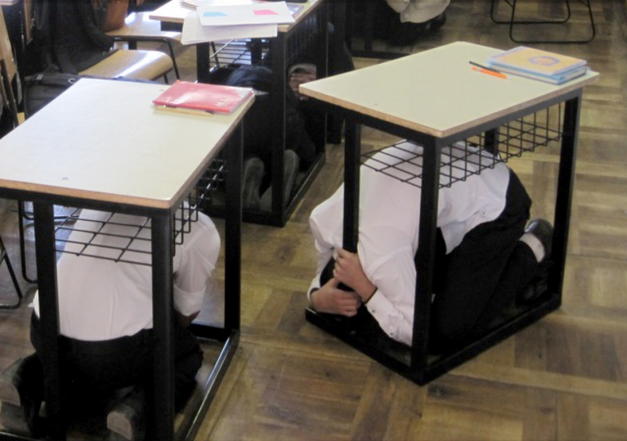 Students at a school in Kyrgyzstan take cover under their desks during the AKDN ShakeOut earthquake drill.