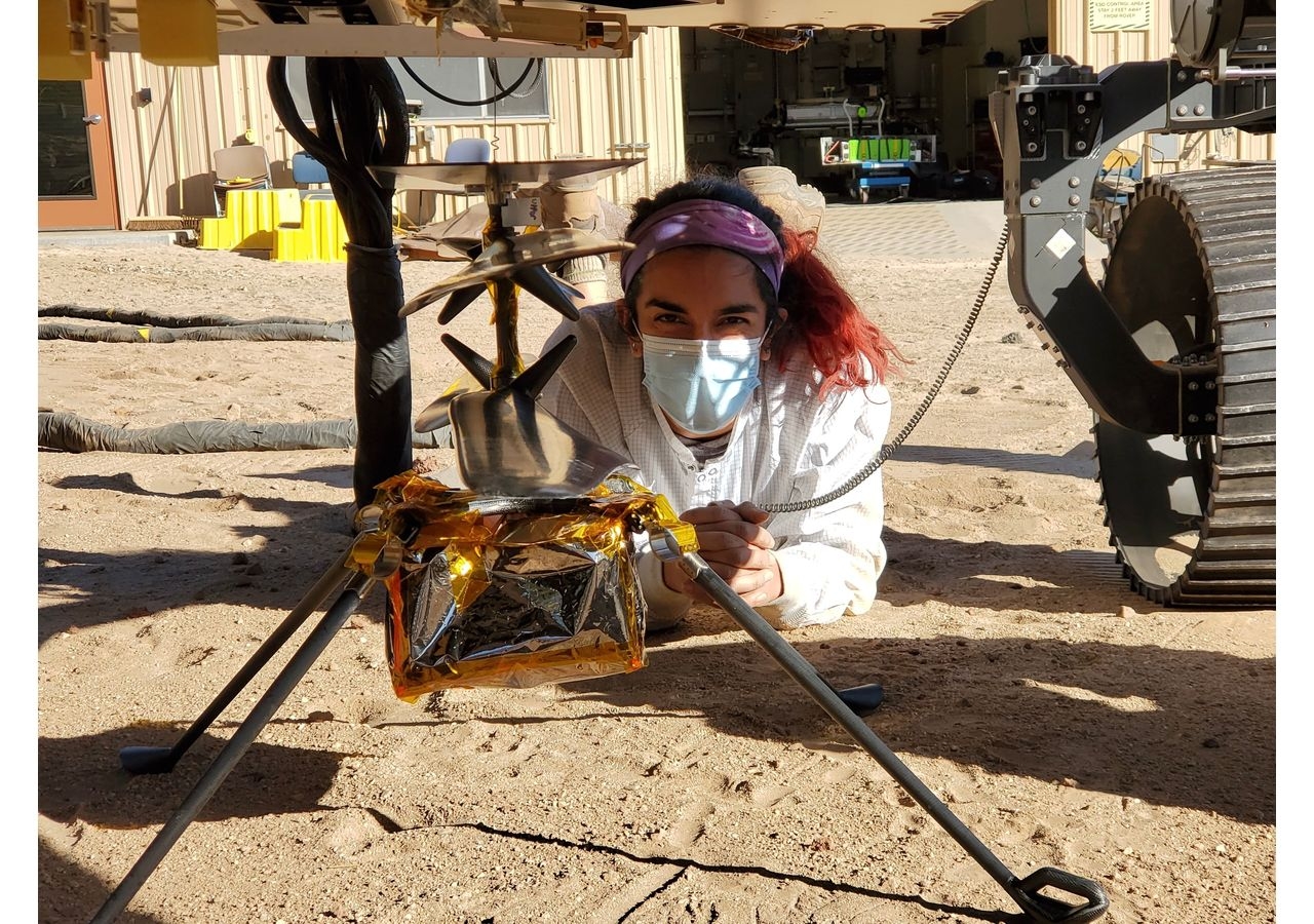 Farah Alibay in NASA’s Jet Propulsion Laboratory's Mars Yard performing tests with a replica of the Ingenuity helicopter.