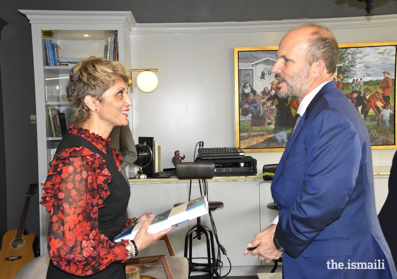 As a gesture of appreciation, Prince Hussain presents a signed copy of his book to Calgary Mayor Jyoti Gondek.