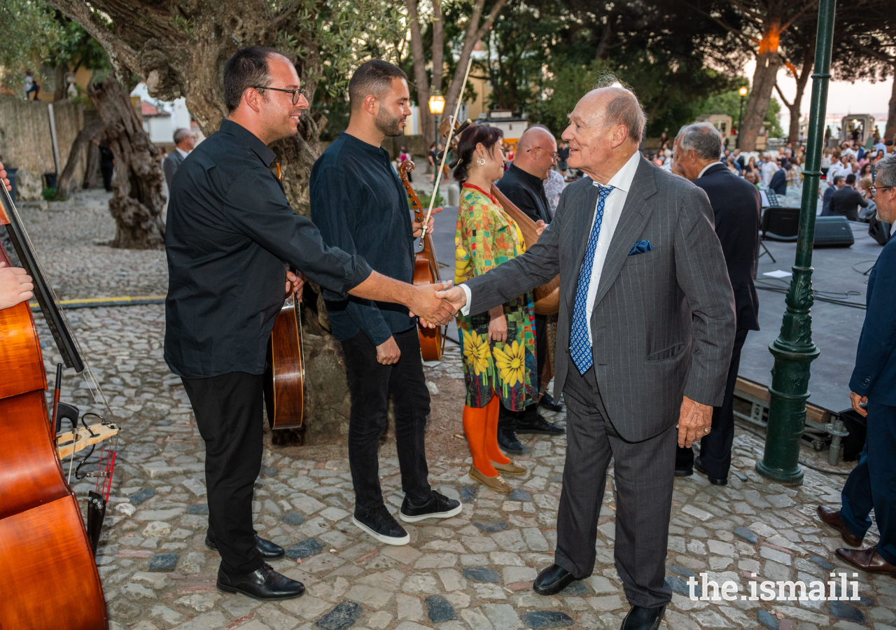 Prince Amyn congratulates guest artist Ricardo Parreira following his performance with the Aga Khan Master Musicians.