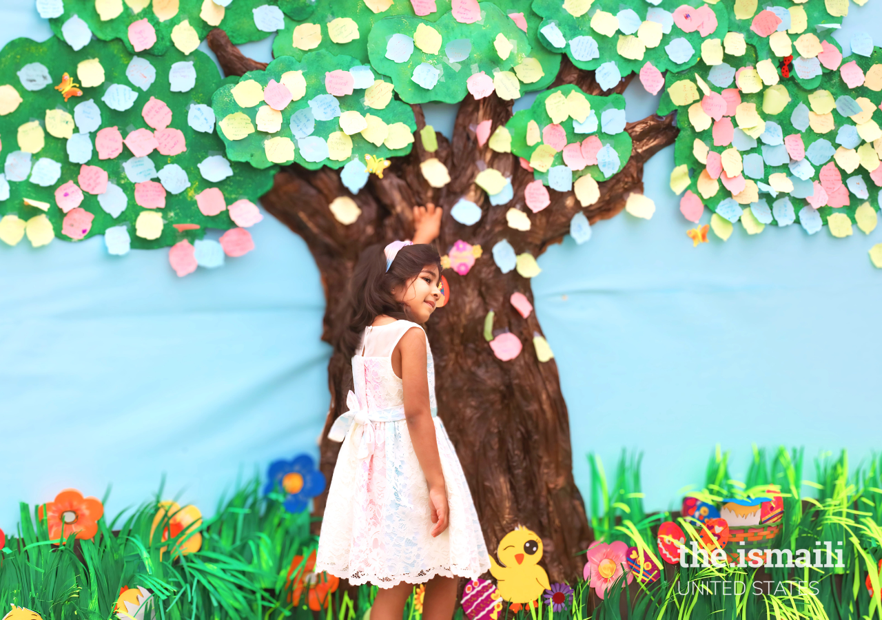 A young member of the Jamat engages with the Navroz wishes tree