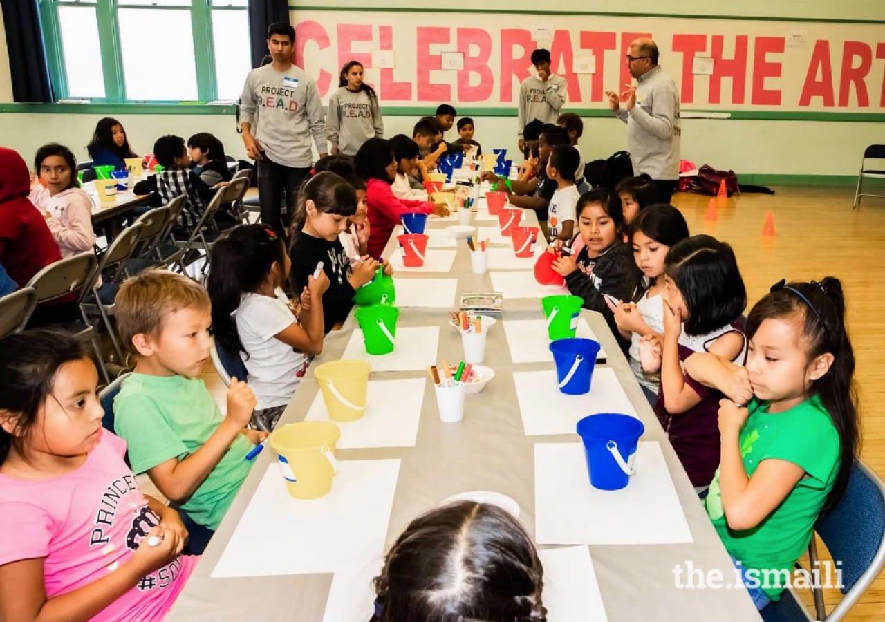 The Students at Brockton Elementary school beginning their first activity of decorating a bucket. Afterward, they will put compliment cards in each of their friend's buckets to further the impact of the book read to them by the Level 11 children.