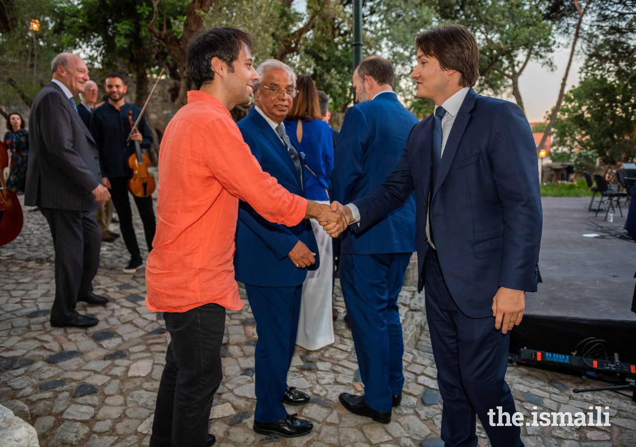 Prince Aly Muhammad congratulates guest artist Marco Oliveira following his performance with the Aga Khan Master Musicians.