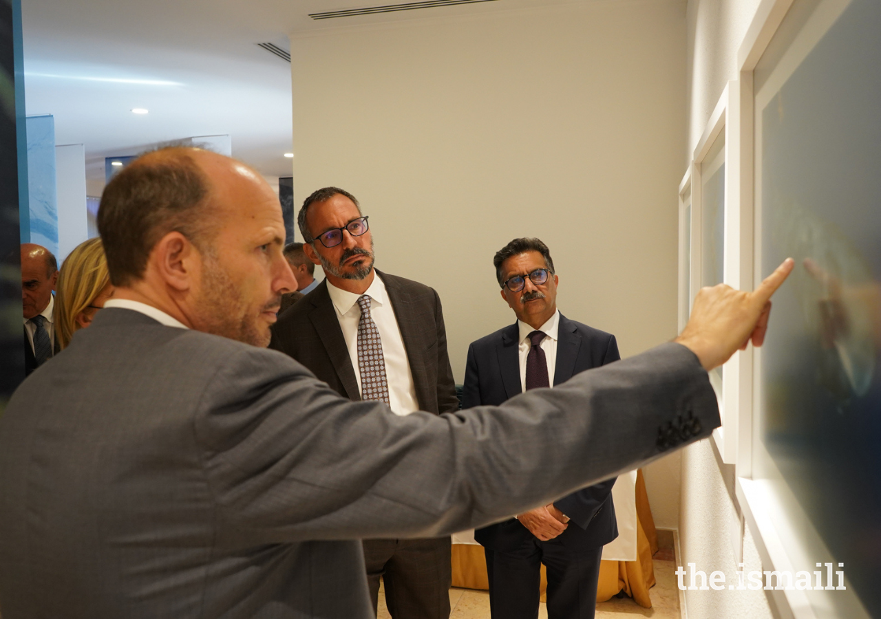 Prince Hussain points out a detail of one of his photographs in the Fragile Beauty exhibition at the Ismaili Centre, Lisbon.