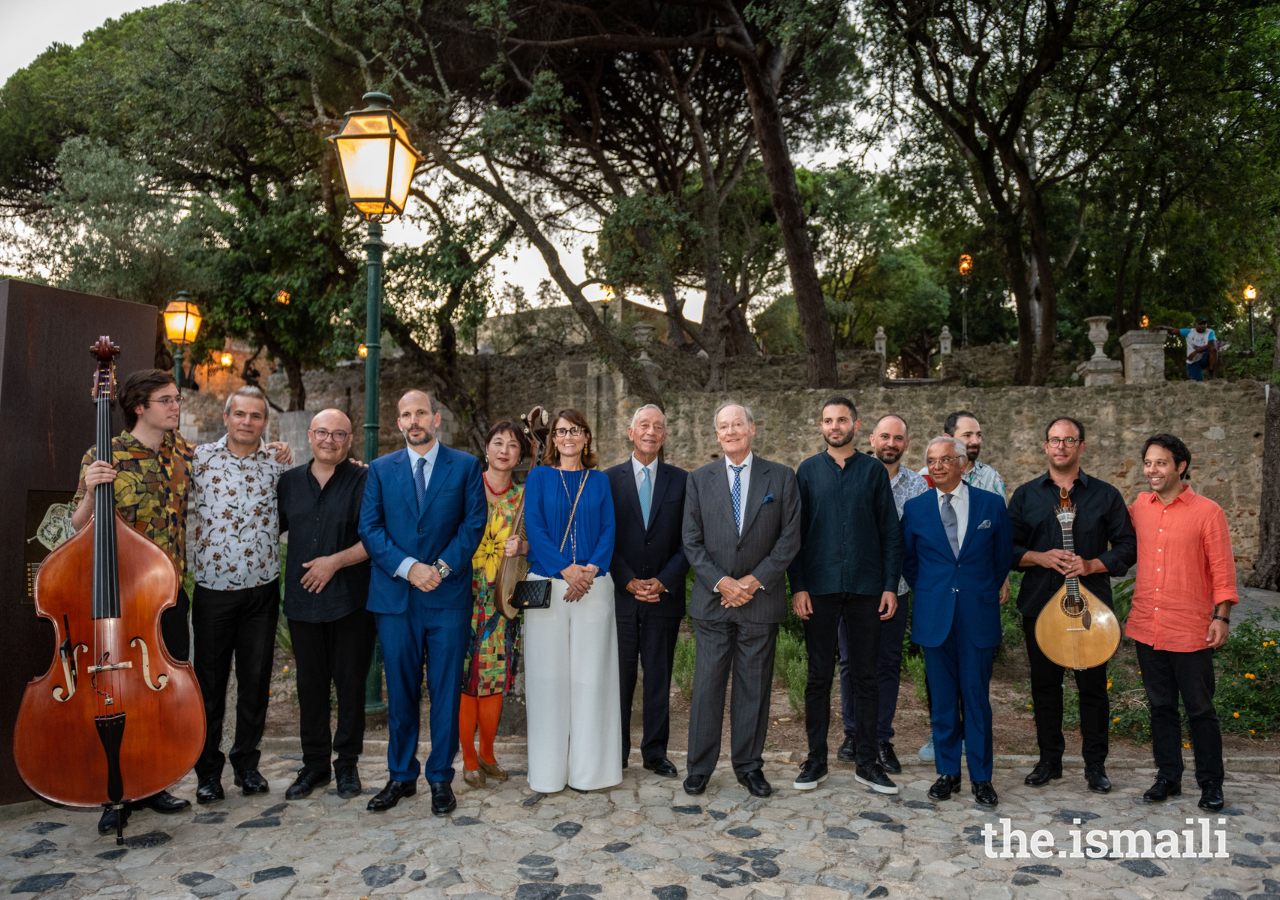 The music artists and guests pose for a group photograph after the concert.