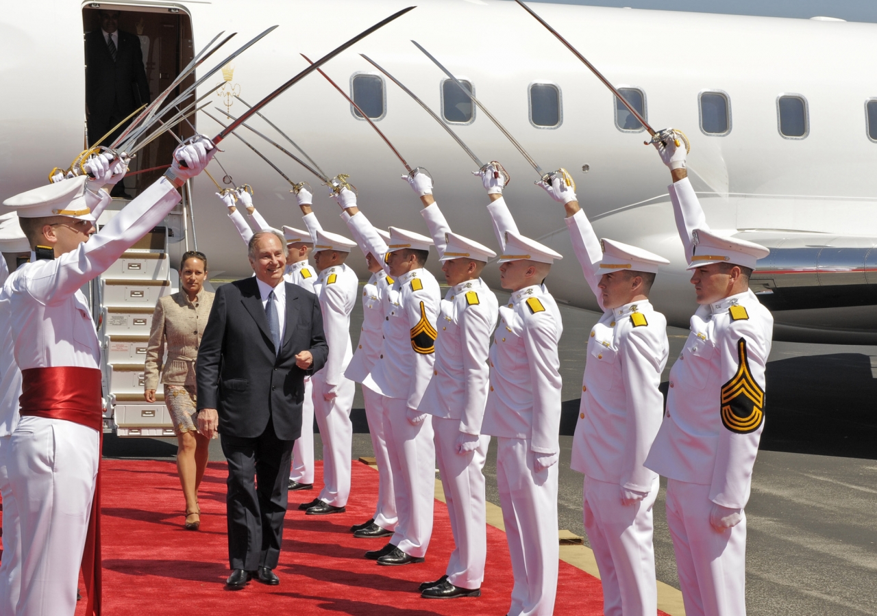 Mawlana Hazar Imam and Princess Zahra walk under a sabre arch salute presented by the Sol Ross volunteers of Texas, as they disembark in Austin, USA. 