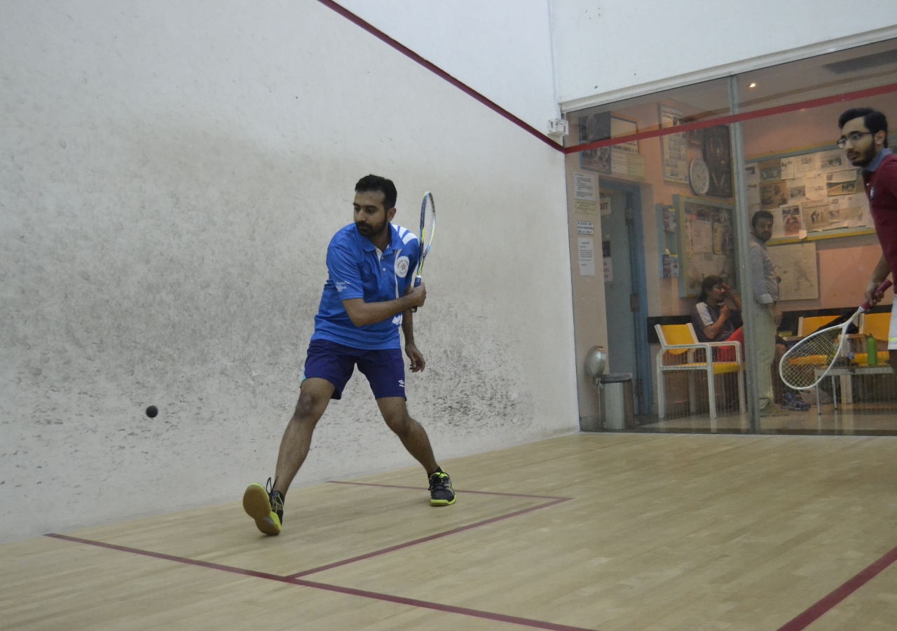 Youth playing a game of squash 