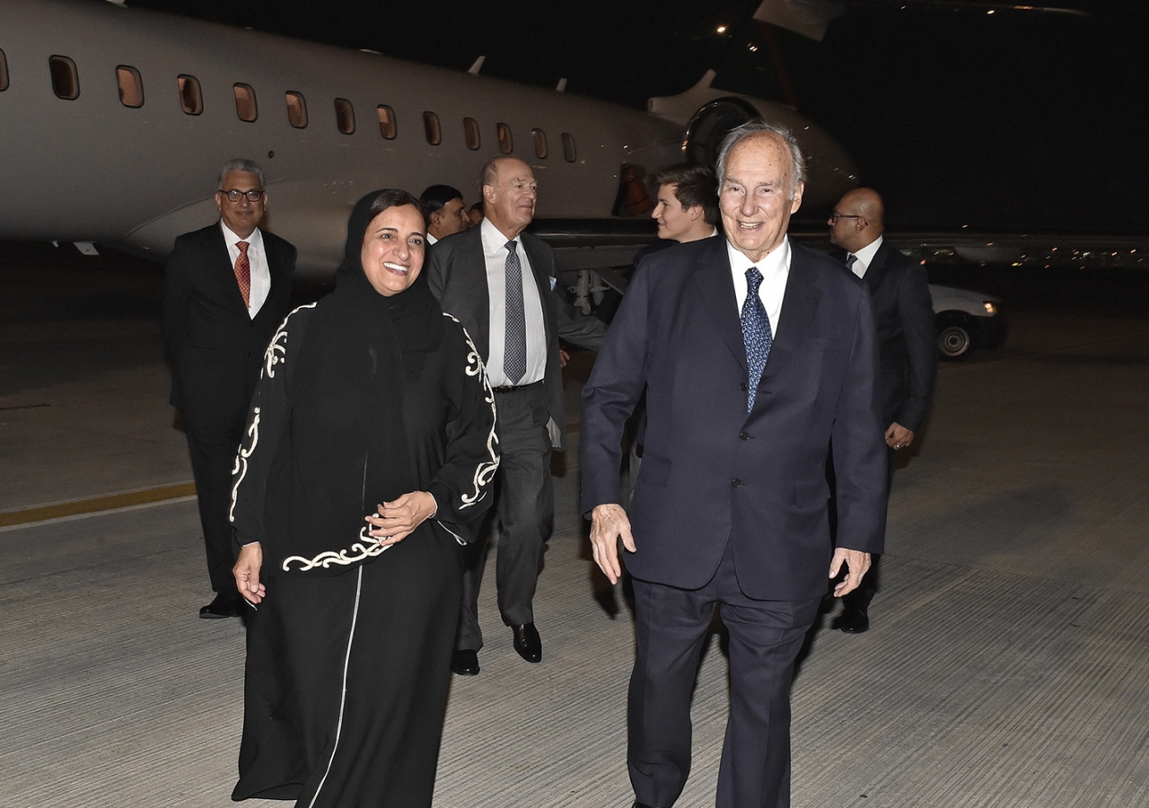 Mawlana Hazar Imam and Minister Sheikha Lubna bint Khalid proceed to the airport terminal as Prince Amyn and Prince Aly Muhammad follow. Gary Otte