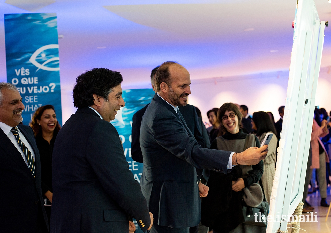 Prince Hussain enjoys a light moment at the inauguration of an exhibition of artwork designed by students from the Portugal Jamat’s Talim (religious education) classes.