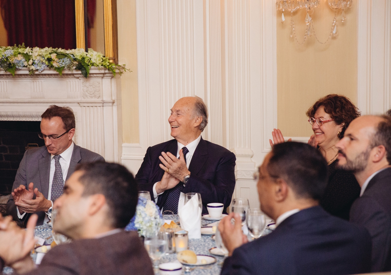 At the dinner that followed the Jodidi Lecture, Mawlana Hazar Imam and Prince Hussain join others in applauding a performance by The Harvard Krokodiloes a cappella singers. Farhez Rayani