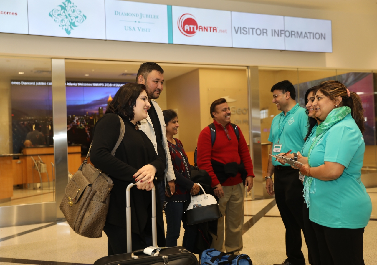 Volunteers welcome Jamati members arriving at Hartsfield-Jackson Atlanta International Airport from around the country for the Atlanta Mulaqat.