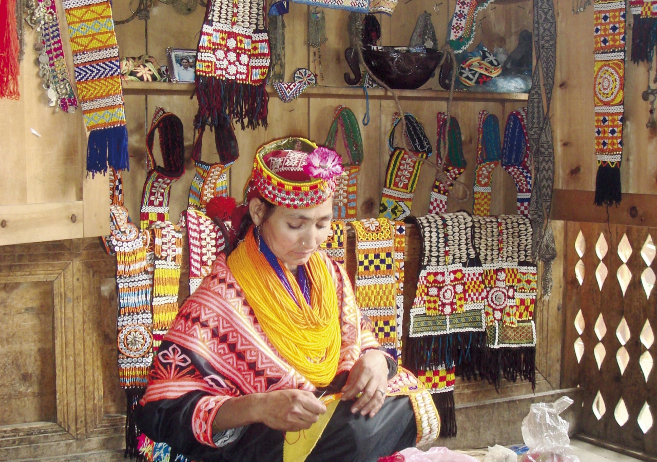 FMFB-P has provided micro loans in the mountainous valley of Chitral called Kalash where this women is making a traditional Kalashi dress in her small shop. Taking a micro loan allows women like this one to send her children to school.