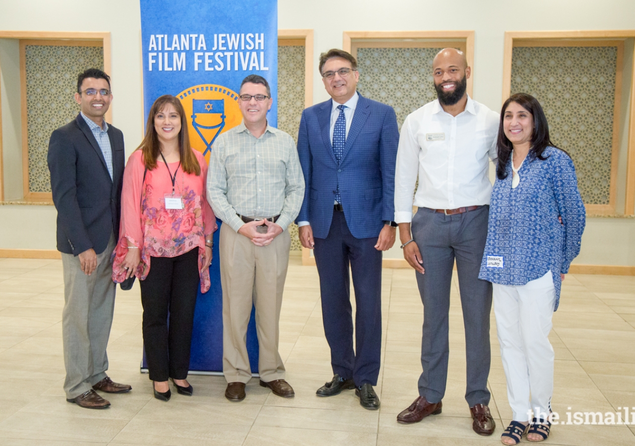 Murad Abdullah, President of the Ismaili Council for the Southeast US,  Kenny Blank, Executive Director of Atlanta Jewish Film Festival (AJFF), Kirkland Carden, City of Duluth Council Member, and other community leaders and volunteers at the presentation 