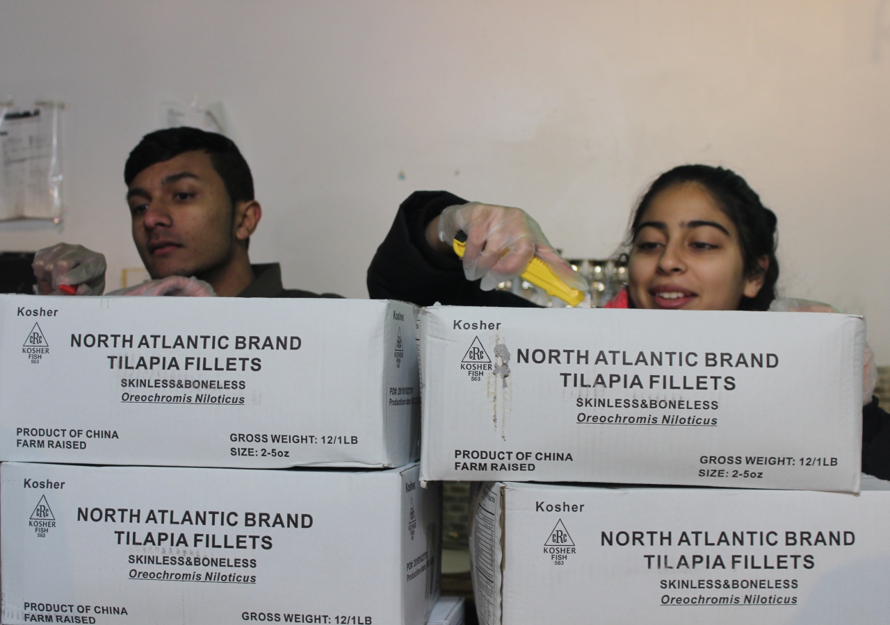 New York I-CERV members open boxes to prepare food for Masbia of Flatbush, a meal delivery service