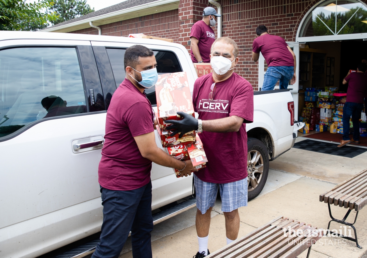 Volunteers in Memphis load and transport COVID-19 Recovery Drive donations for the Mid-South Food Bank.