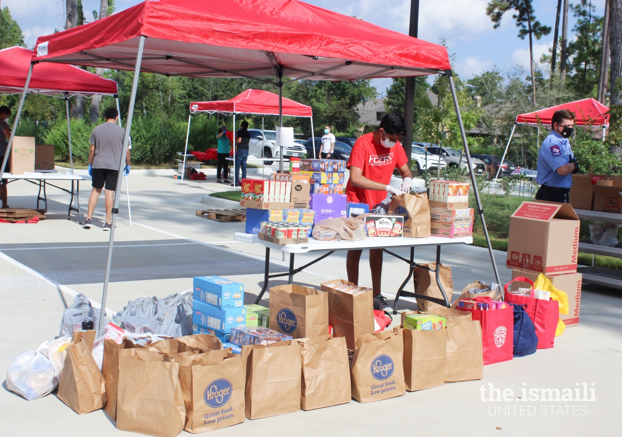 I-CERV and Spring Fire Department volunteers working together to assist with the collection and sorting of food items received by members of the community.