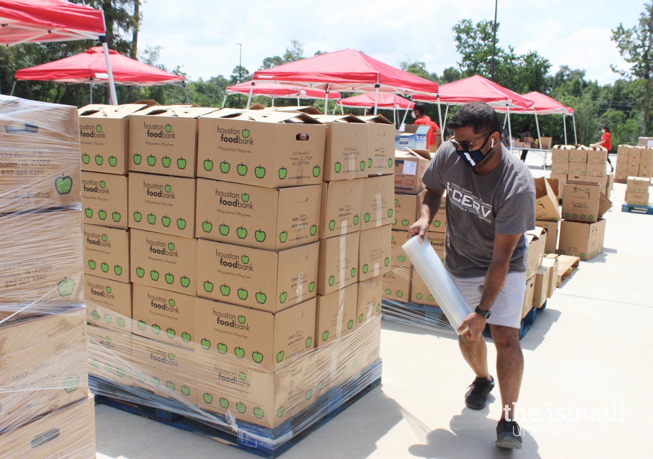 I-CERV volunteer wrapping one of 17 pallets of donations collected during the food drive at the Ismaili Jamatkhana in Spring, TX.