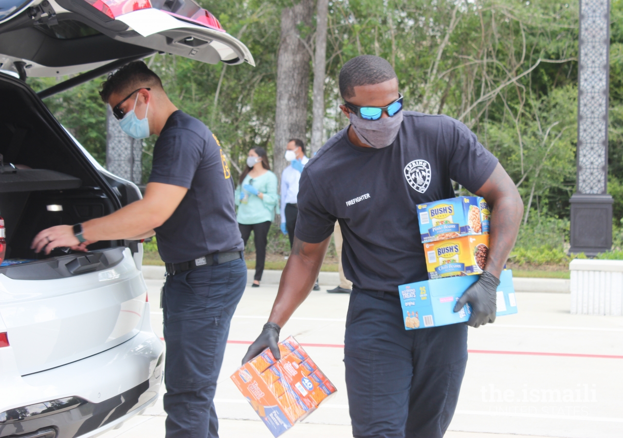 Firefighters from the Spring Fire Department assisting with food donations.