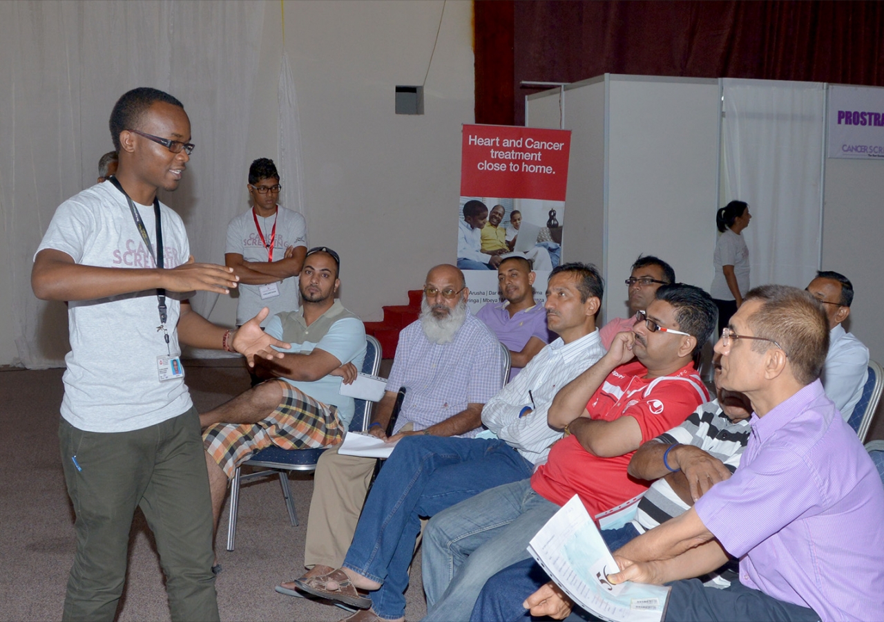 In Dar es Salaam, men learn about the importance of early detection while waiting to be screened for oral and prostate cancers; women were screened for cervical, breast and oral cancers in a separate area. Ismaili Council for Tanzania