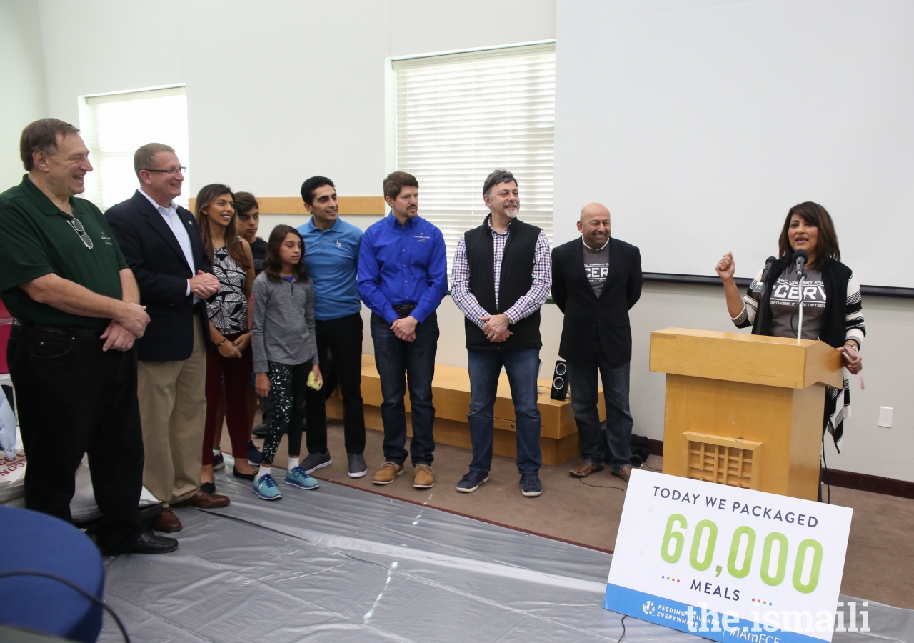 Council member Samina Hooda explaining how the meal ingredients are of high nutritional value, and how the speed of packing synchronized with the beat of selected music.