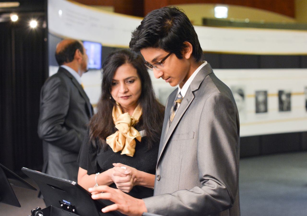 A volunteer assisting a guest with an evaluation of the exhibition