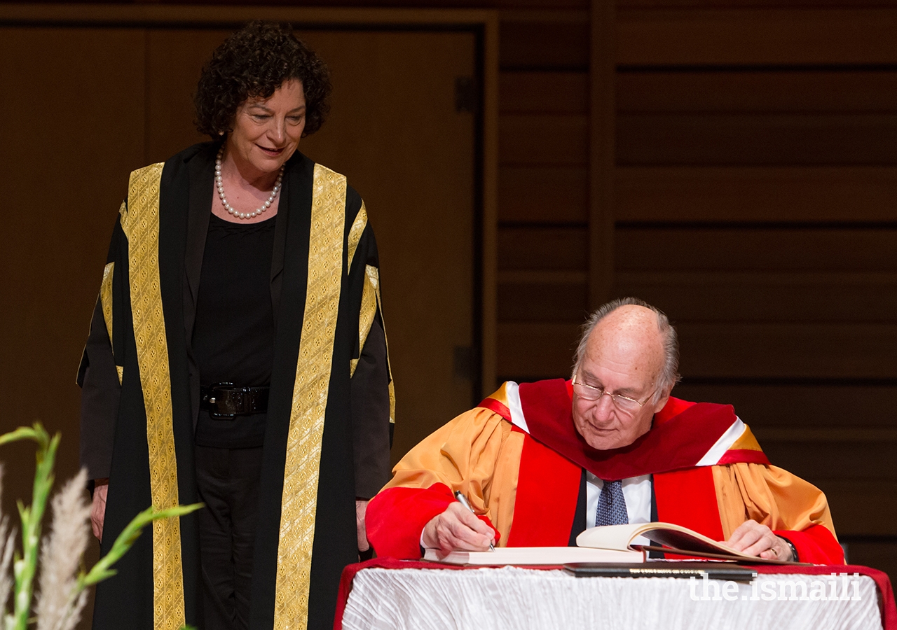 Mawlana Hazar Imam completes the honorary degree conferral ceremony with the signing of the register.