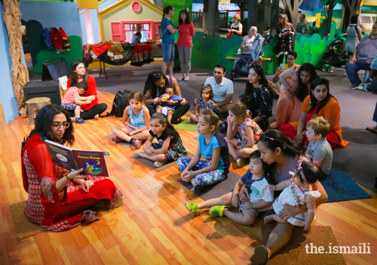 Laila Aziz reads stories to children at the Atlanta Children's Museum during the Meet the Holidays celebration.