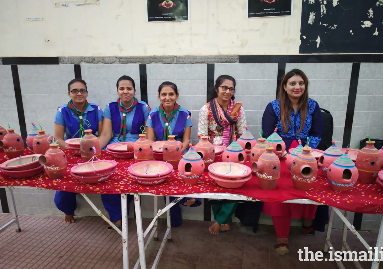 The Jamati Members and volunteers embracing the counter showcasing many types of bird feeders which would then be distribute among the houses nearby