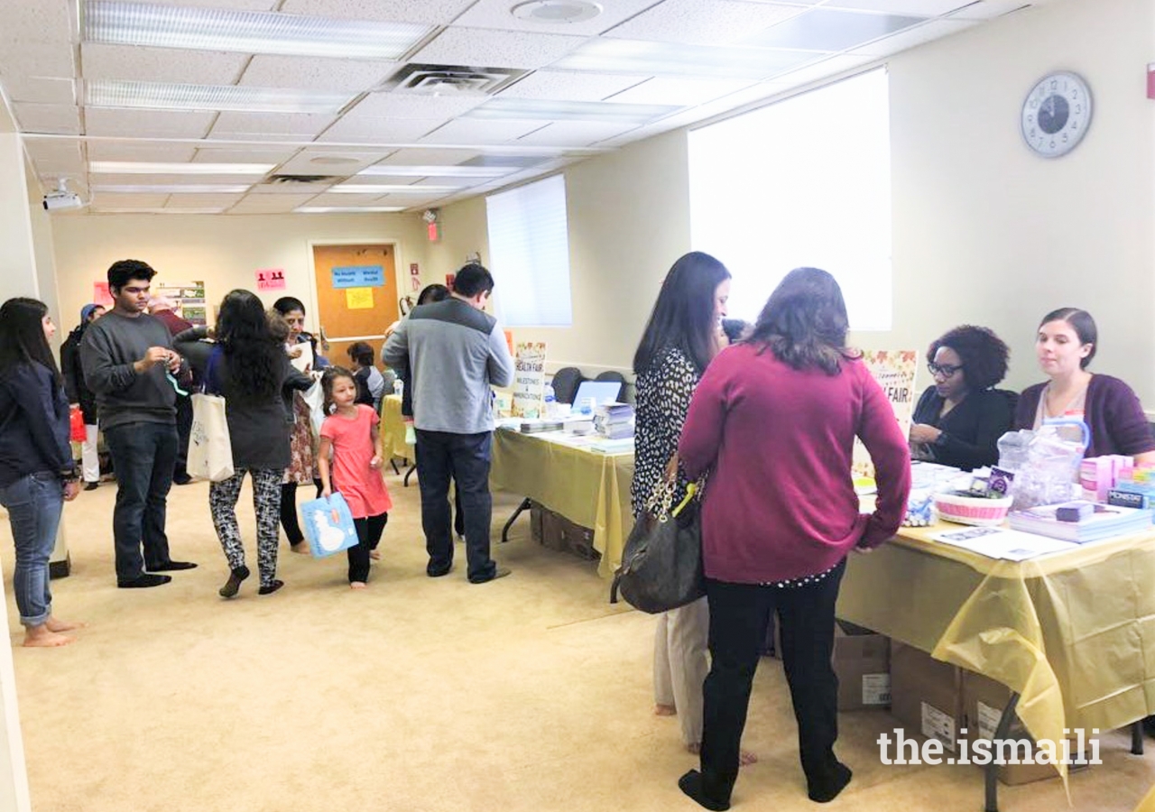 Jamati members browse informational booths to learn about health issues.