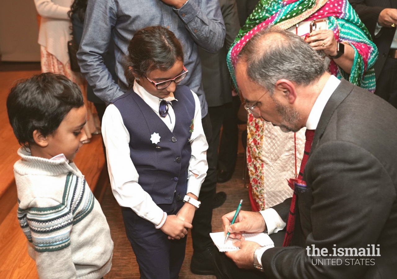 Farrokh Derakshani with a young volunteer impressed with his presentation.