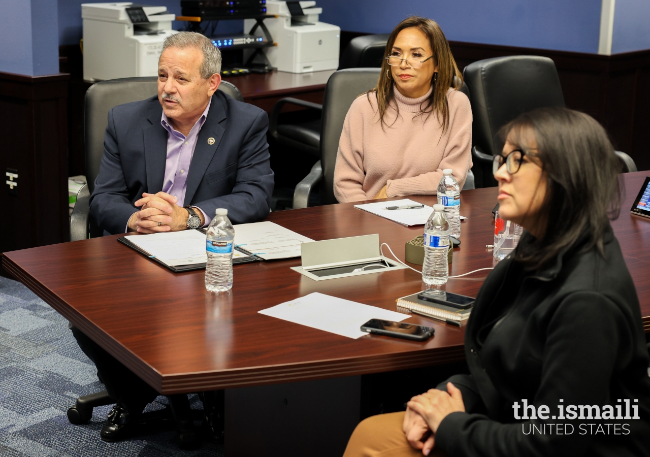 Mark Glilarducci, CalOES Director, Helen Lopez, Asst. Director in the Office of International Affairs of CalOES, and Christina Curry, Chief Deputy Director of CalOES, listened to one of the remote participants prior to the ceremony.