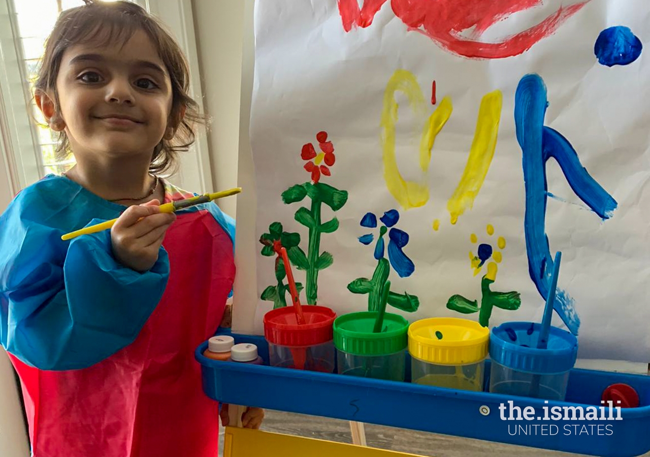 A Fam360 participant paints with her family after the positive parenting session.