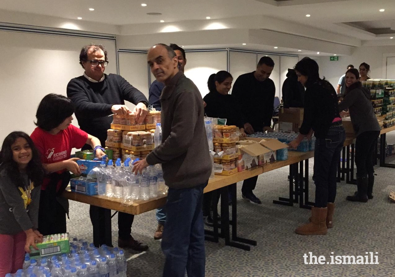 Members of the Jamat in the UK gather to pack sustenance bags for homeless and vulnerable individuals in London.