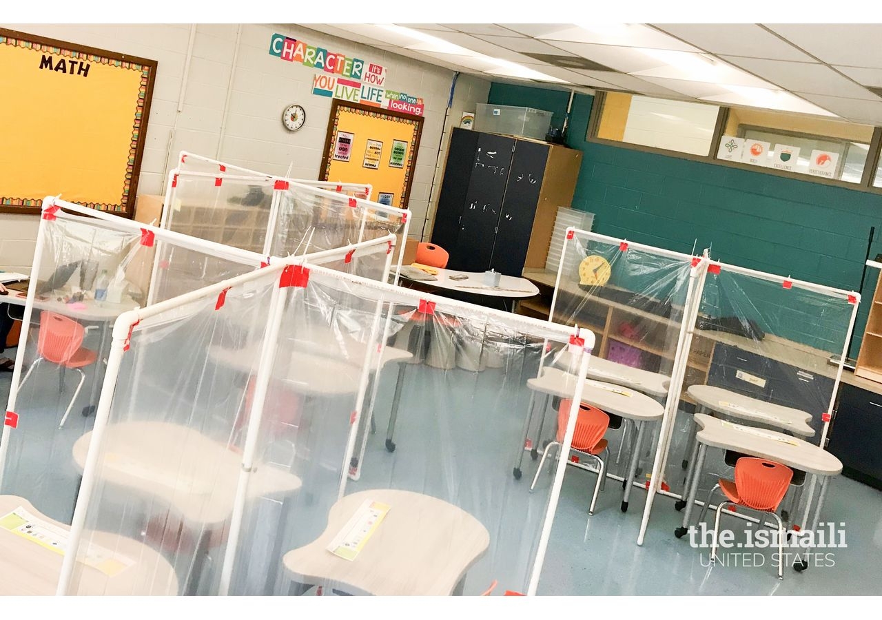 View of a classroom with desk partitions to separate students.