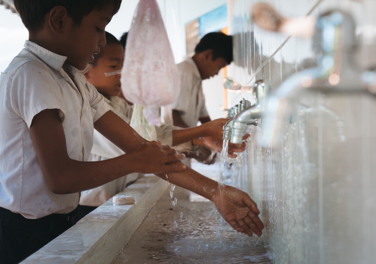 Students at Ponheary Ly Foundation's school wash their hands upon arriving in school.