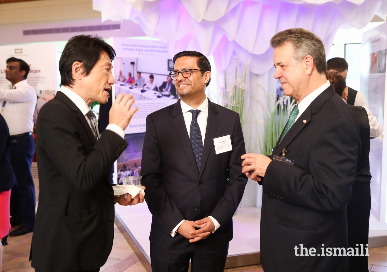 President of the Aga Khan Council for Southwestern United States Murad Ajani, engages with guests viewing the AKDN Ethics in Action exhibit.