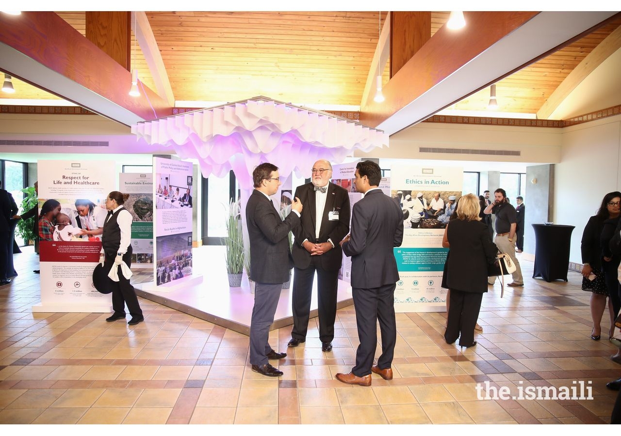 Consuls General engage with members of the Aga Khan Council for Southwestern United States as they view the AKDN Ethics in Action exhibit.