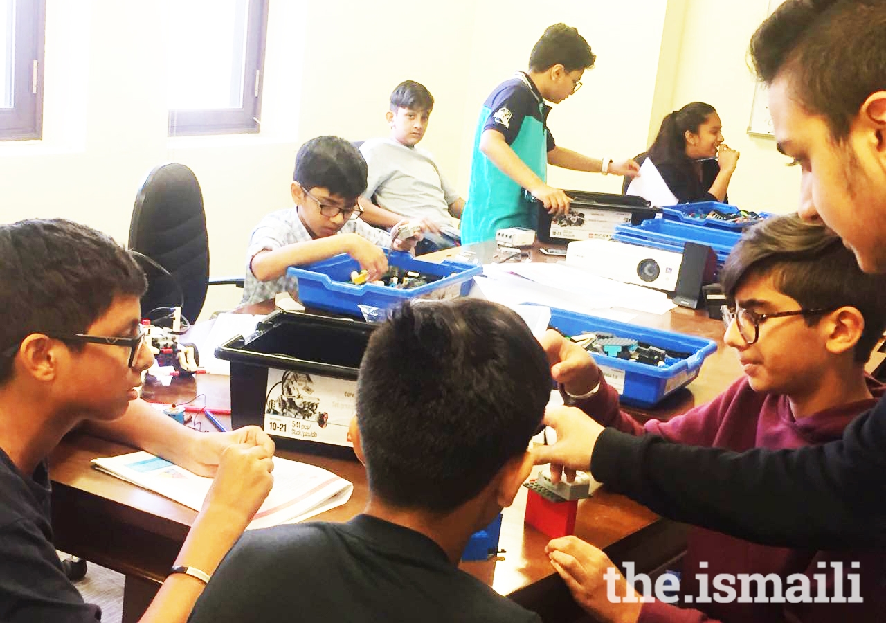 Youth engage in a robotics competition using LEGO