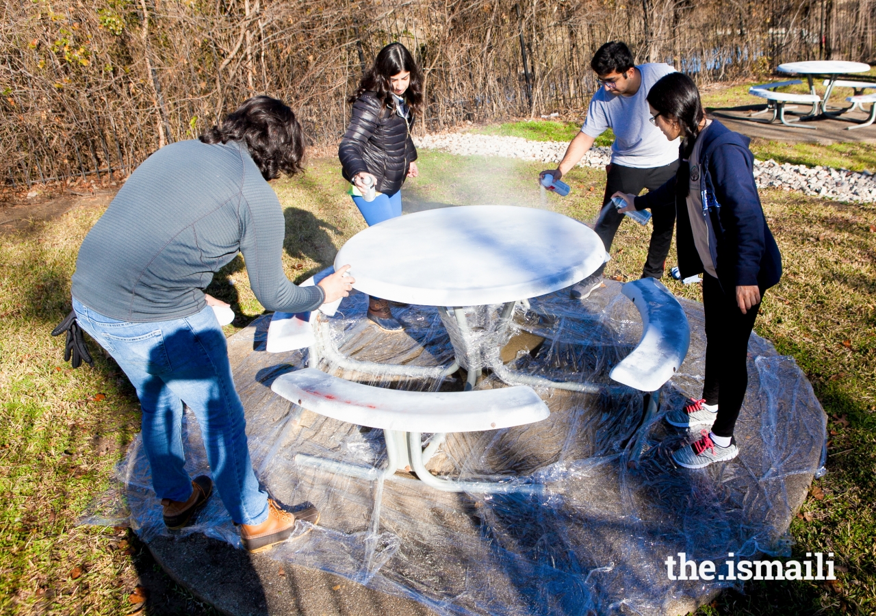 AWB participants help beautify Marillac Community Center in Dallas, by painting benches and tables, landscaping, and helping clean up.