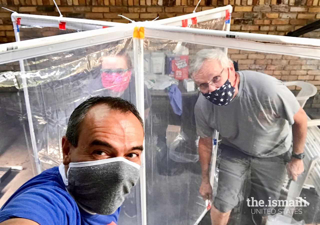 Dr. Karim Budhwani  and Dr. Craig Wilson constructing their classroom desk partitions.