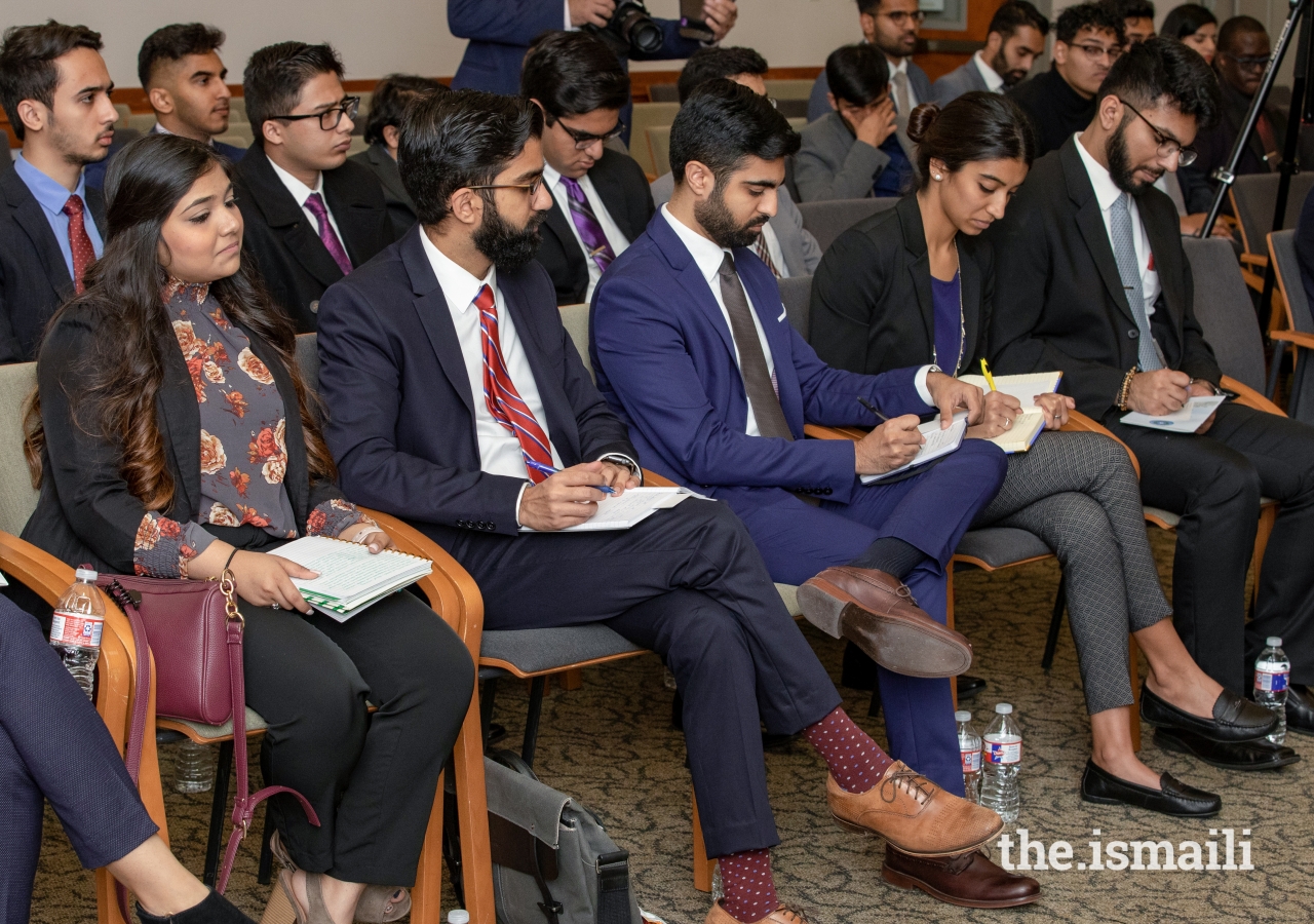 Students and young professionals taking notes as they listen to the presentations by the state officials.