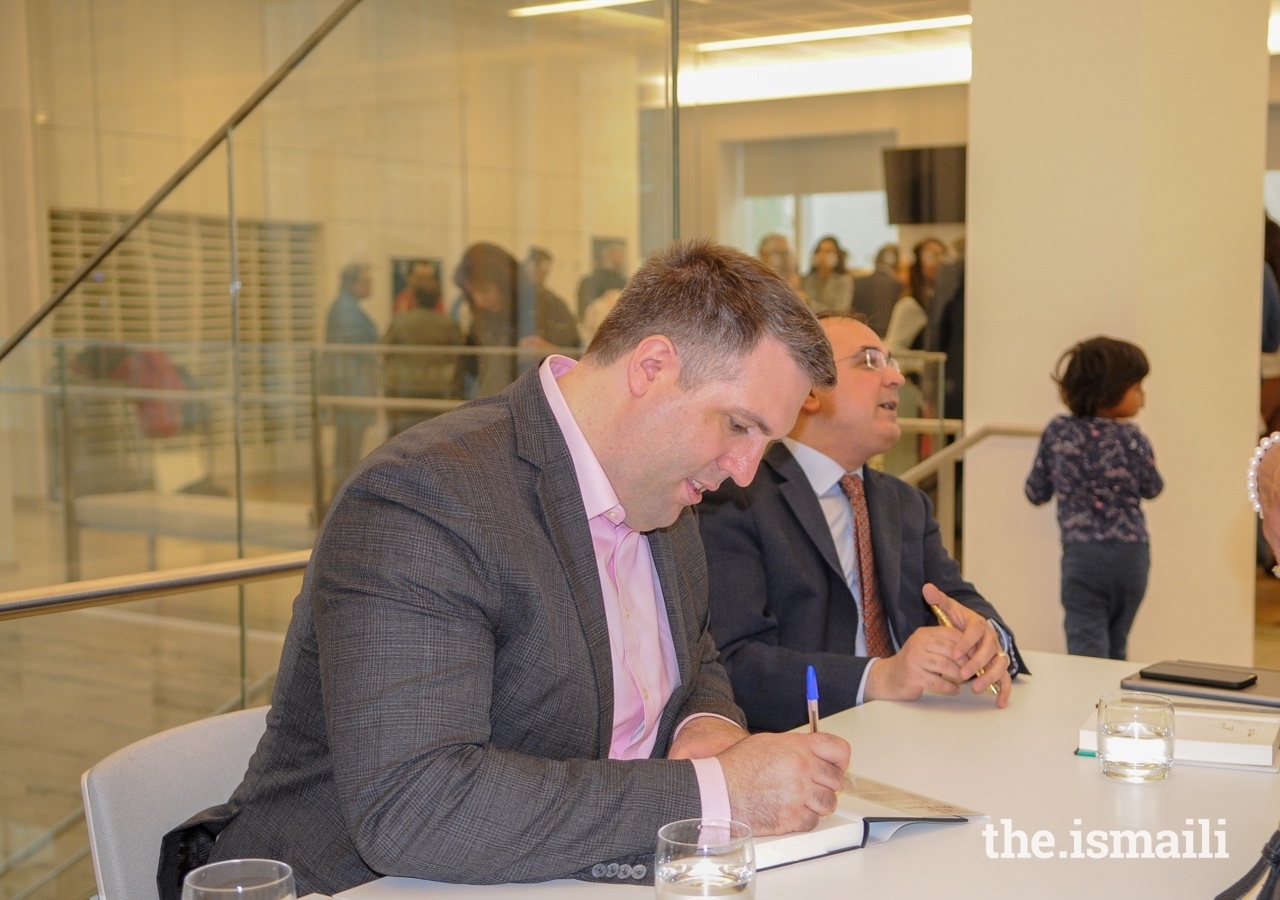 Dr Daniel Beben signs copies of 'The First Aga Khan: Memoirs of the 46th Ismaili Imam' at the book launch event in London.