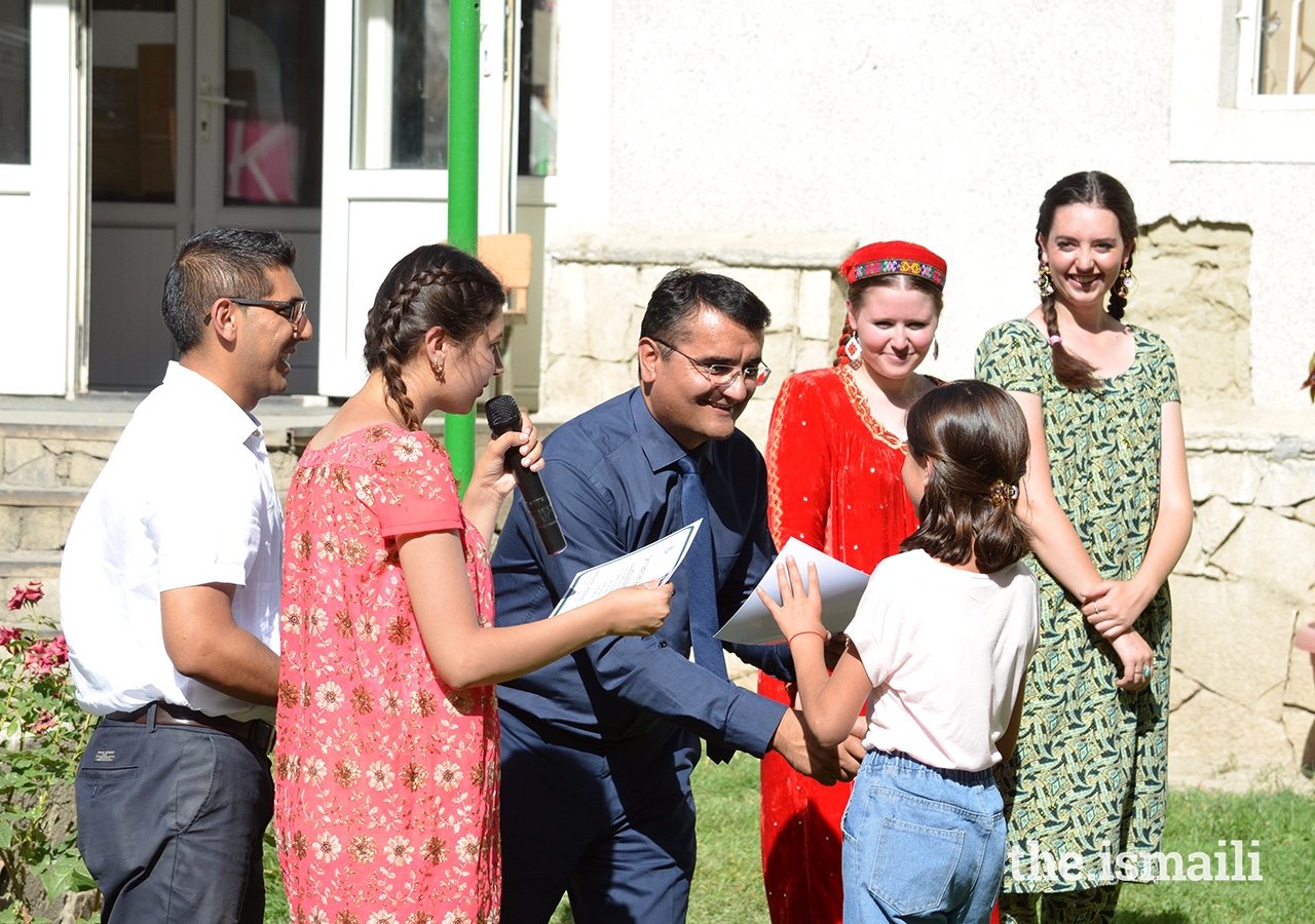 Participants receive certificates upon completion of the summer Makerspace Lab programme from Zuloby Mamadfozilov, AKES Tajikistan's CEO, and the programme facilitators, Faith Harron and Allison Armstrong.