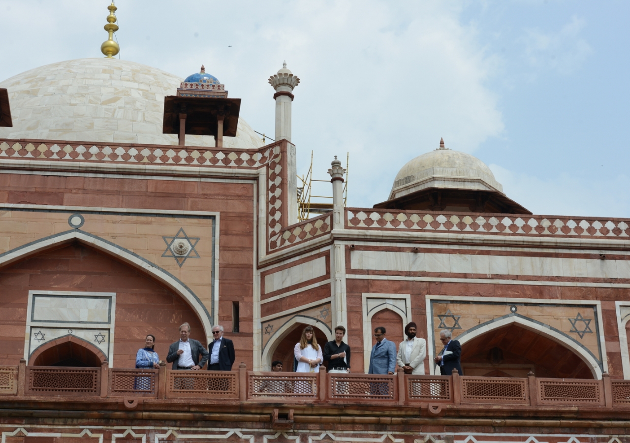 Princess Zahra, her daughter Sara and Prince Aly Muhammad take in a view of the gardens surrounding Humayun’s Tomb, together with AKTC staff, during a visit in 2015.