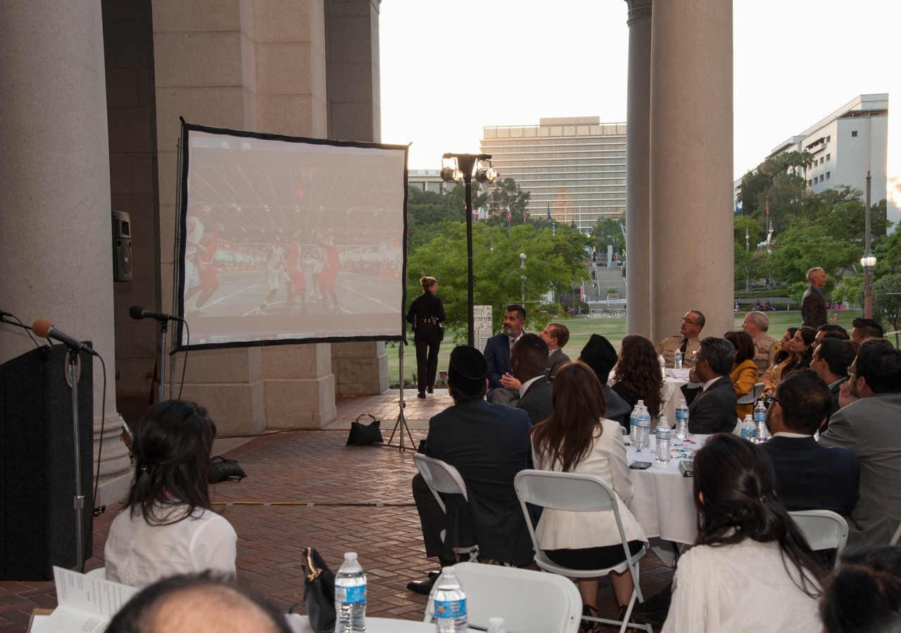 Guests in the courtyard of the Los Angeles City Hall viewing a video describing the activities of the Aga Khan Council for the Western United States. 