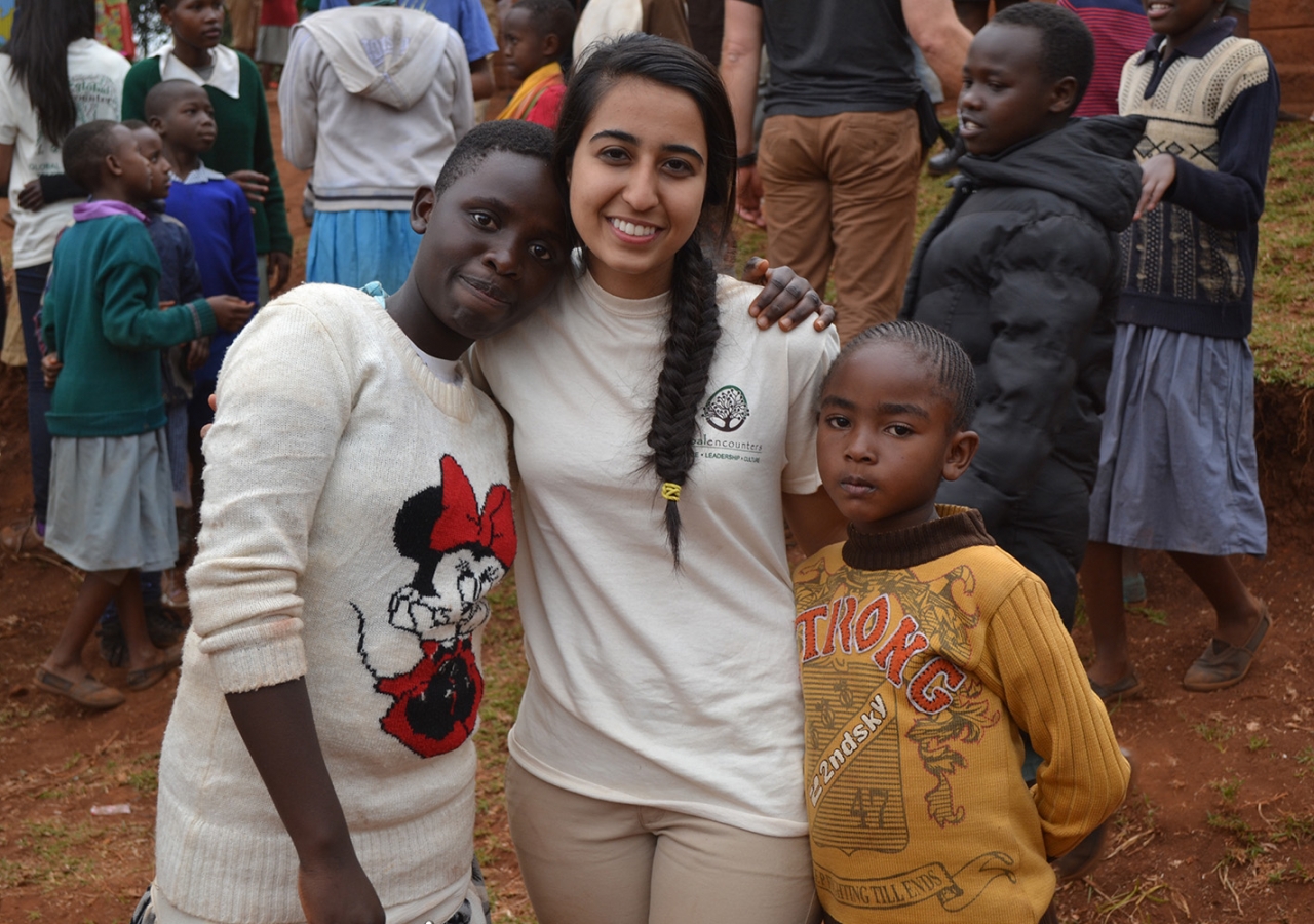 A Global Encounters participant with children at her service site. Saraan Jiwani