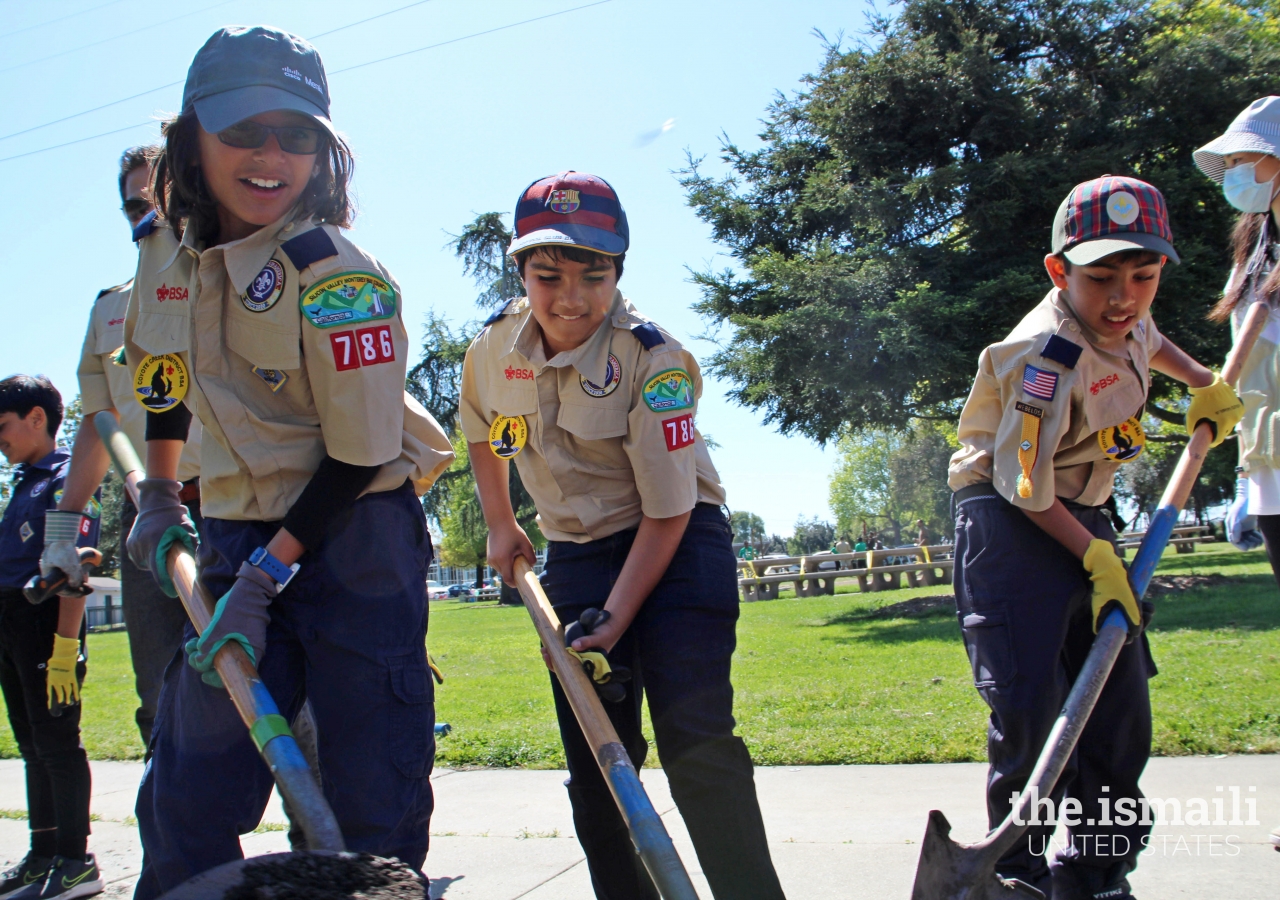 Scouts digging and preparing the soil to plant trees.