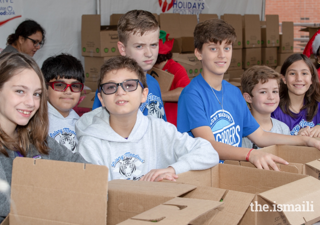 Several students who participated in the Share Your Holidays Food Drive helped package donated items.